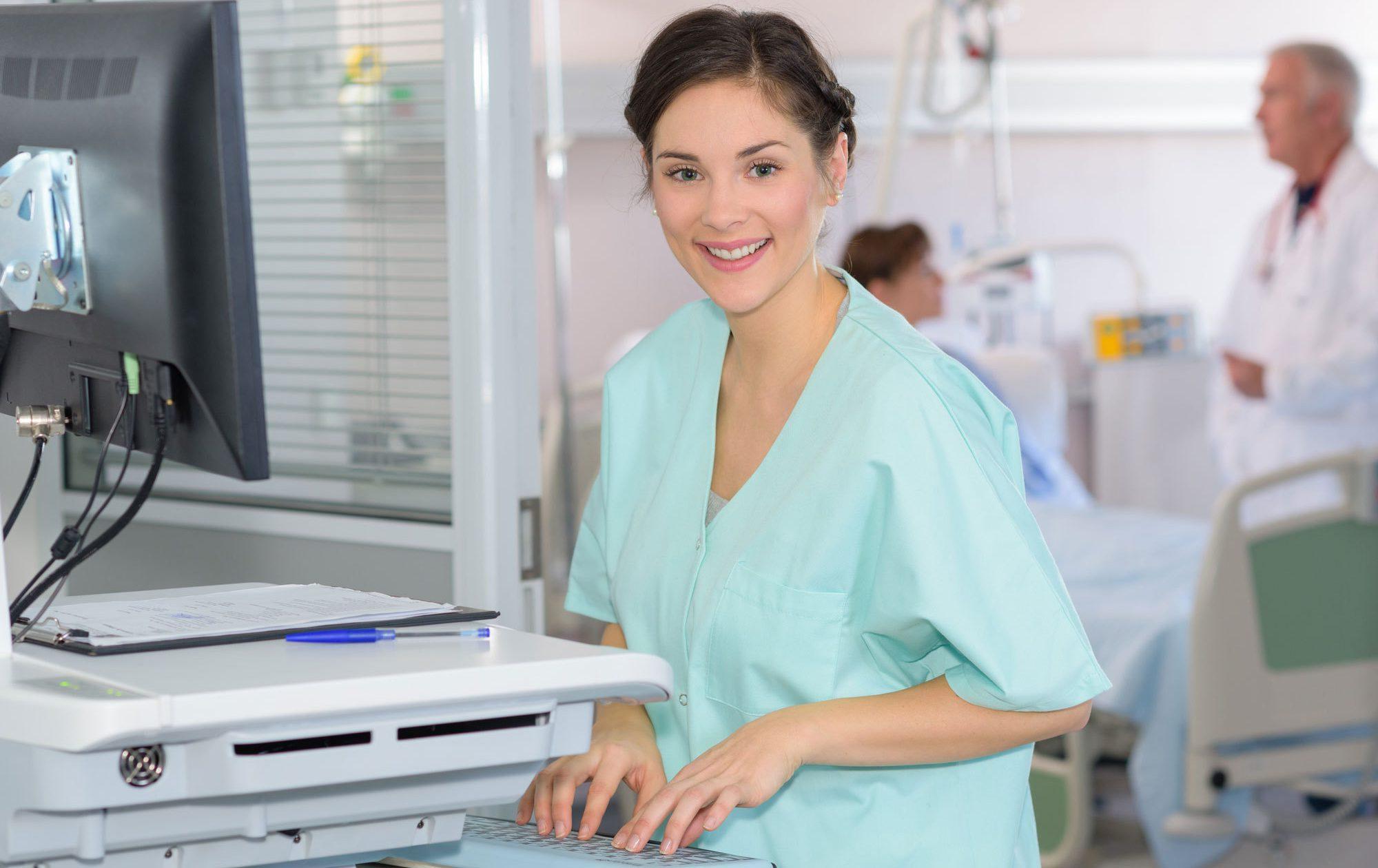 A female BSN is smiling and at work